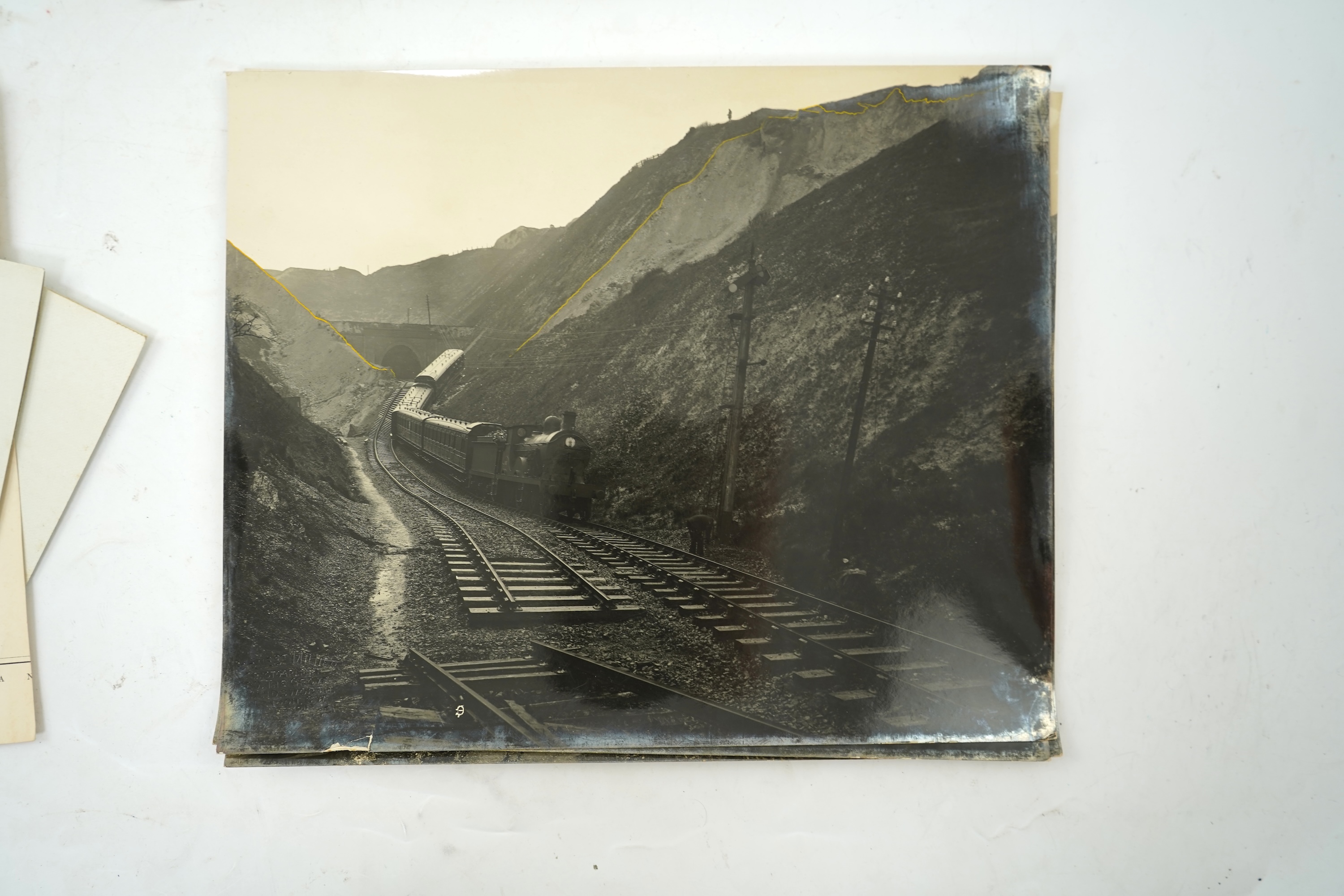 Fourteen late 19th/early 20th century black and white photographs of the results of a chalk landslide on the SE&CR, South East and Chatham Railway, at East Wear Bay, Capel-le-Ferne, Kent, with annotations to the reverse